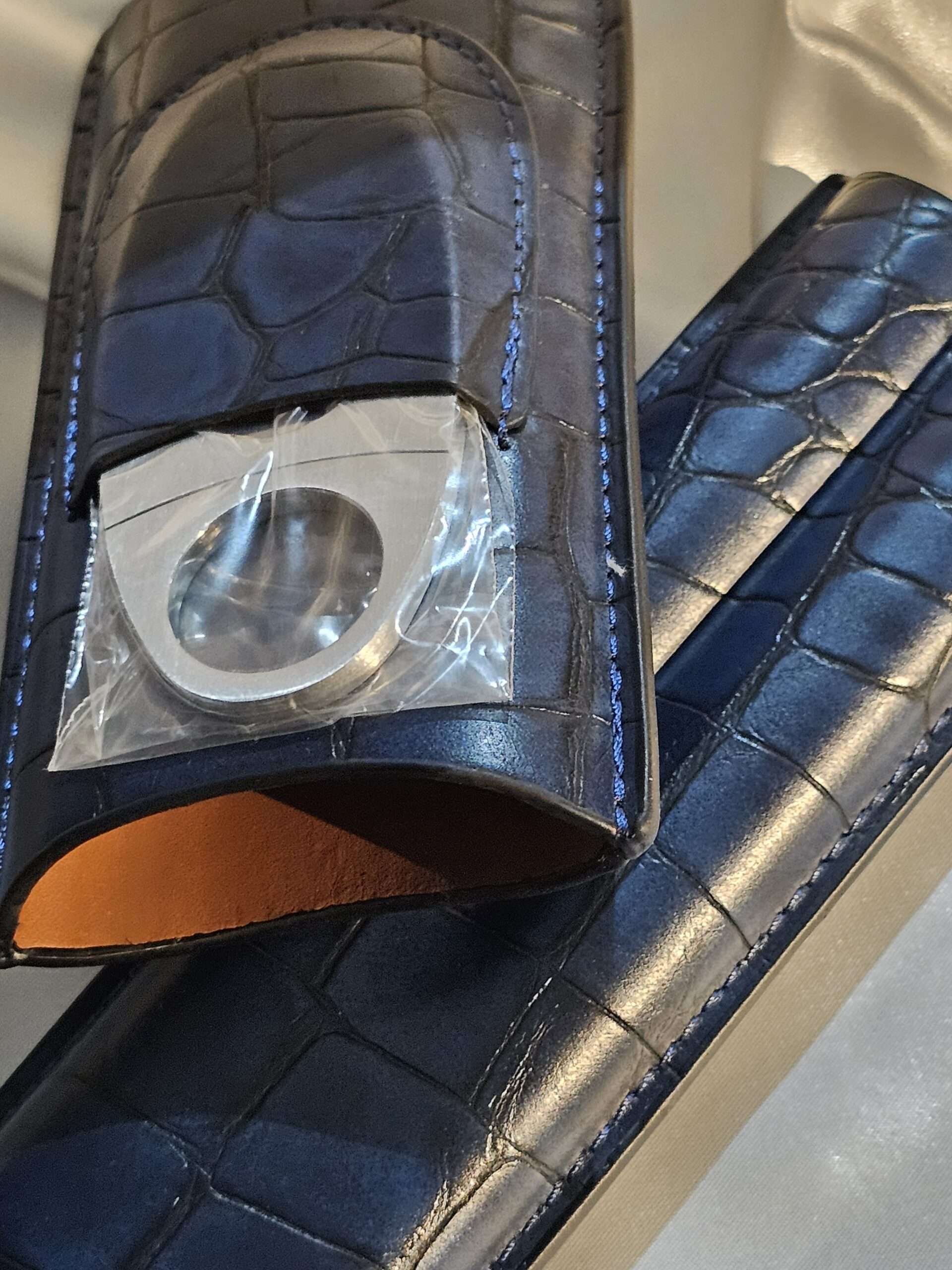 an open view of cigar case with cutter attached
